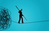 Businessman walking away carefully from tangled rope