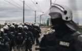 a photo of Serbian police units in riot gear guard the entrance to the Old Sava Bridge in Belgrade on November 20, 2024, during of a protest