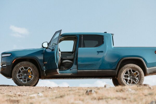Blue Rivian R1T side view, driver door open
