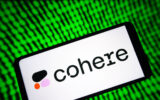 Image of a phone with Cohere's logo on it with a green digital background.